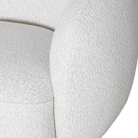 Cream swivel chair close-up showing textured upholstery detail.