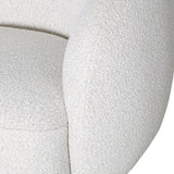 Cream swivel chair close-up showing textured upholstery detail.