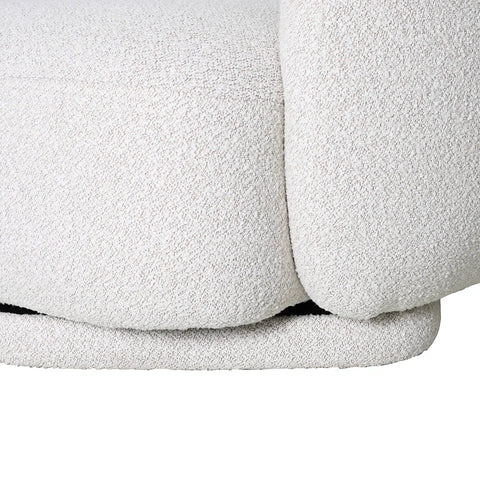 Cream boucle chair detail with soft, textured upholstery.