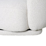 Cream boucle chair detail with soft, textured upholstery.