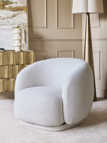 Light grey swivel chair in a cozy living room with modern decor.