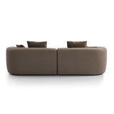 Back view of a brown velvet sofa with plush cushions.