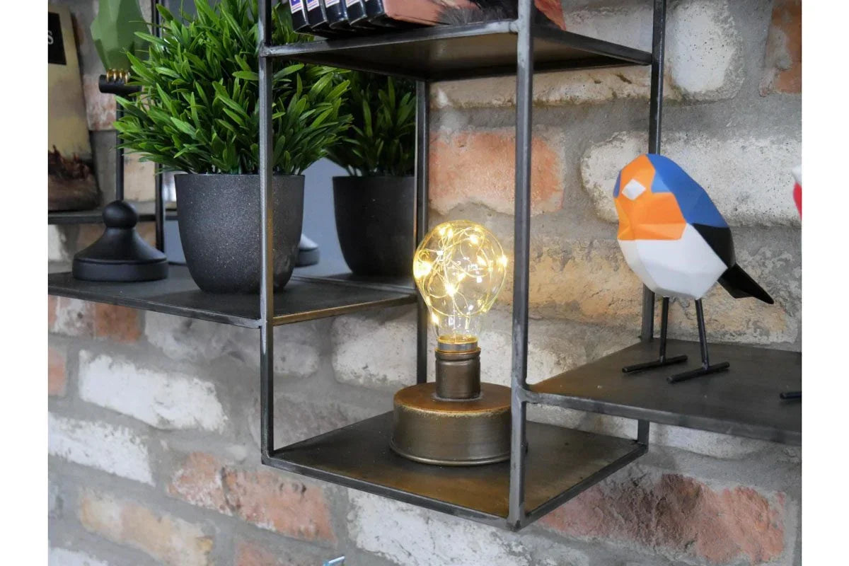 Industrial wall shelf with potted plant, decorative bulb lamp, and geometric bird ornament