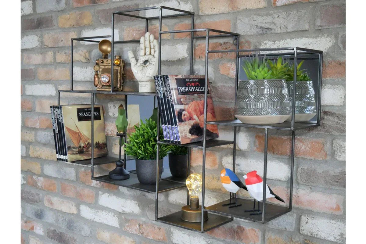 Black metal wall shelf with books, decorative ornaments, and potted plants on brick wall