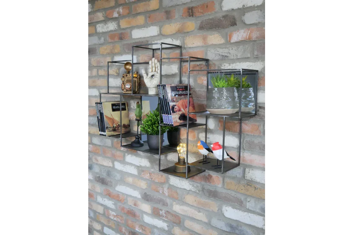 Wall mounted black metal display shelves with books, plants, ornaments, and decorative birds
