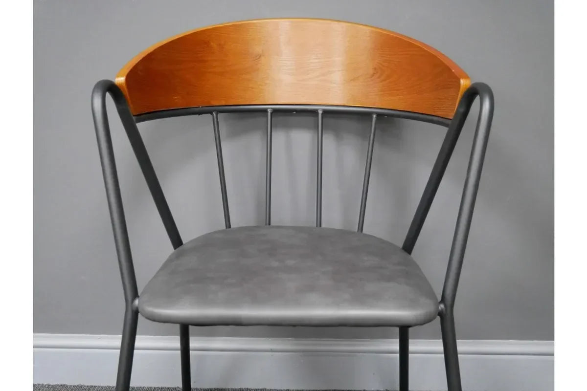 Modern dining chair with curved wood backrest, black metal frame, and grey upholstered seat
