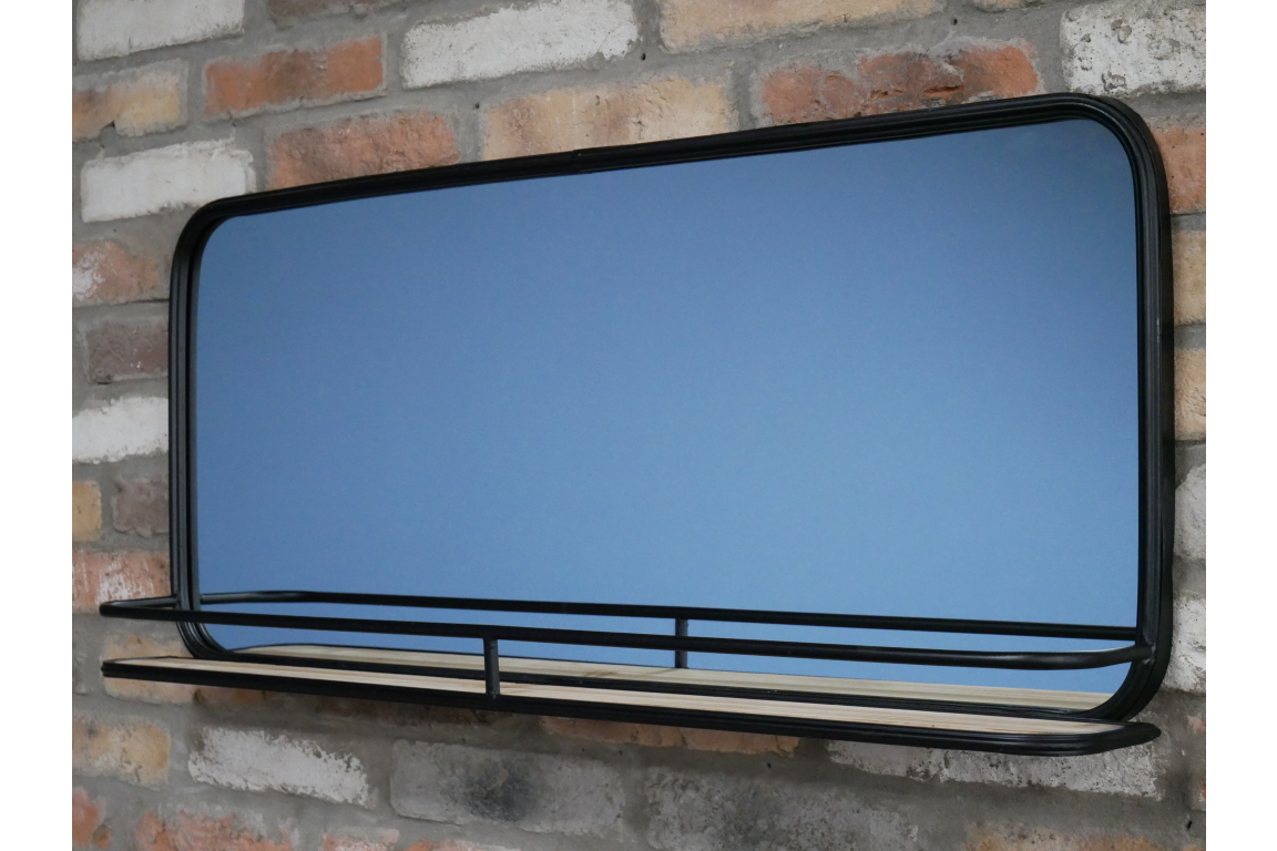 Rectangular wall mirror with rounded corners and black metal frame featuring a narrow wooden shelf, side angle view.