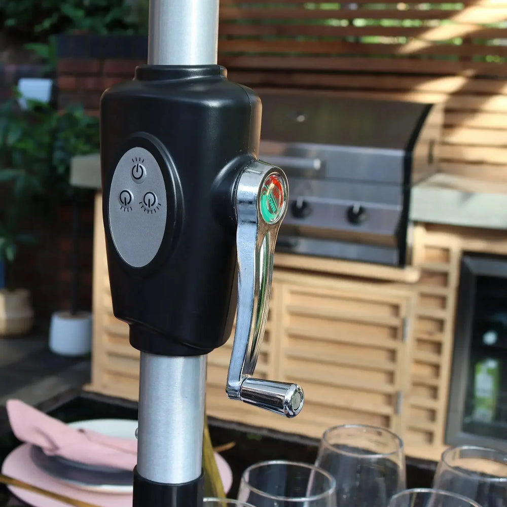 Close up of garden parasol crank handle with control buttons on patio