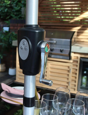 Close up of garden parasol crank handle with control buttons on patio