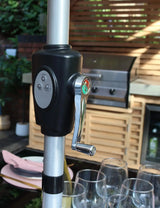 Close up of garden parasol crank handle with control buttons on patio