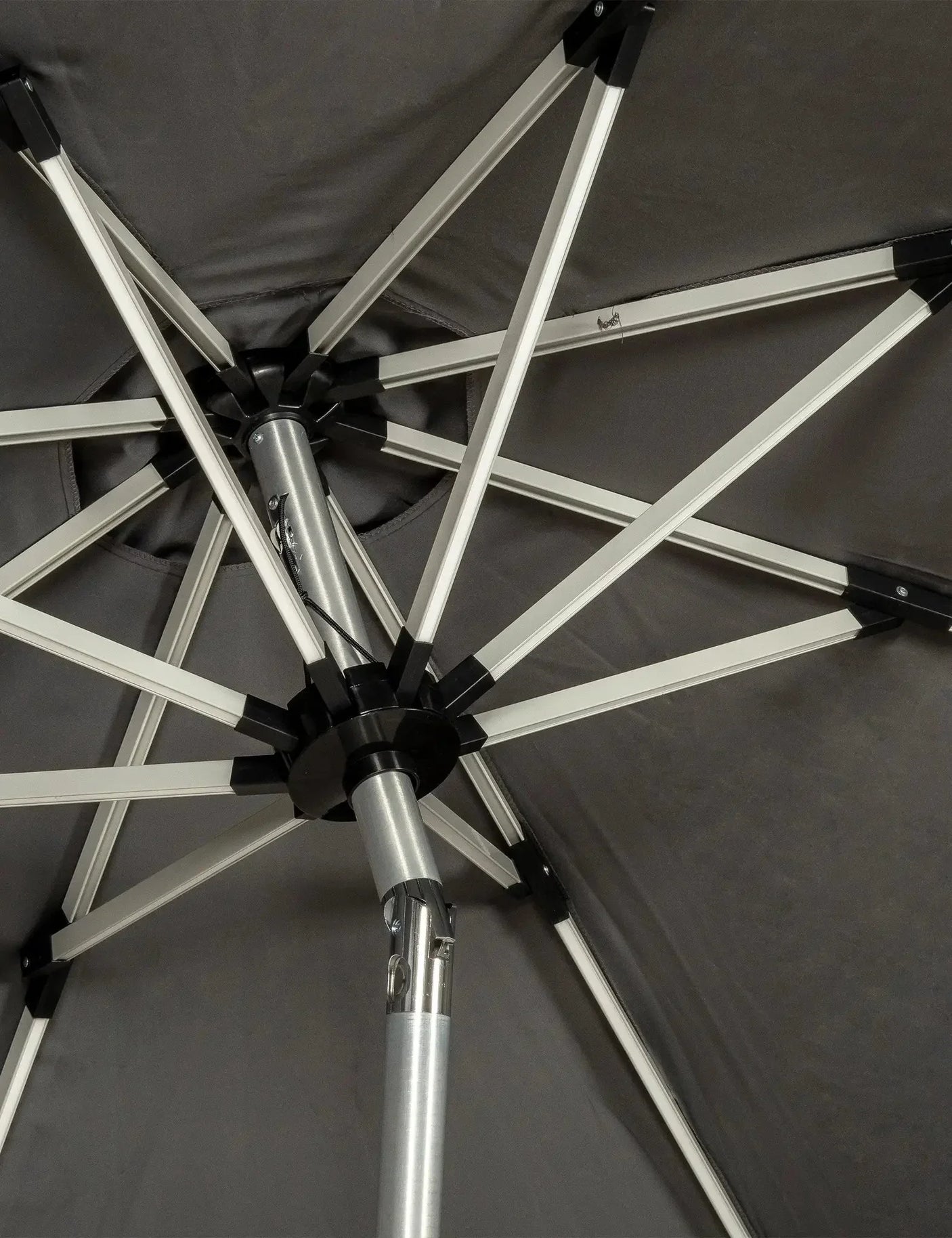 Aluminium garden parasol frame and support ribs viewed from below, grey canopy