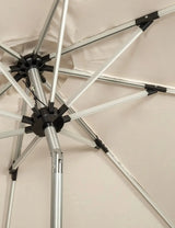 Close up of outdoor parasol frame with silver metal ribs and beige canopy fabric