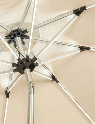 Close-up of beige garden parasol with metal frame and tilt mechanism