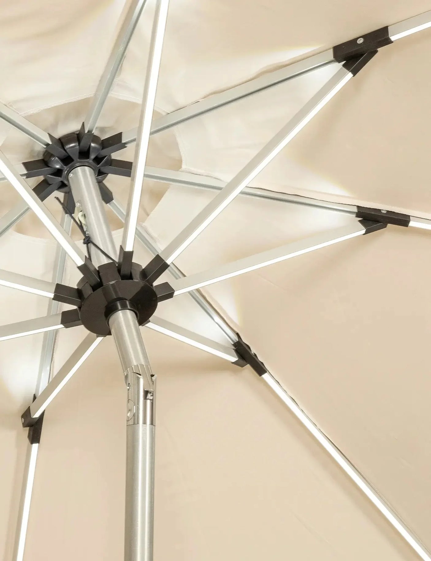 Close-up of beige garden parasol with metal frame and tilt mechanism