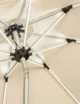 Close-up of beige garden parasol with metal frame and tilt mechanism