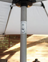 Close up of outdoor parasol pole with tilt mechanism beneath white canopy