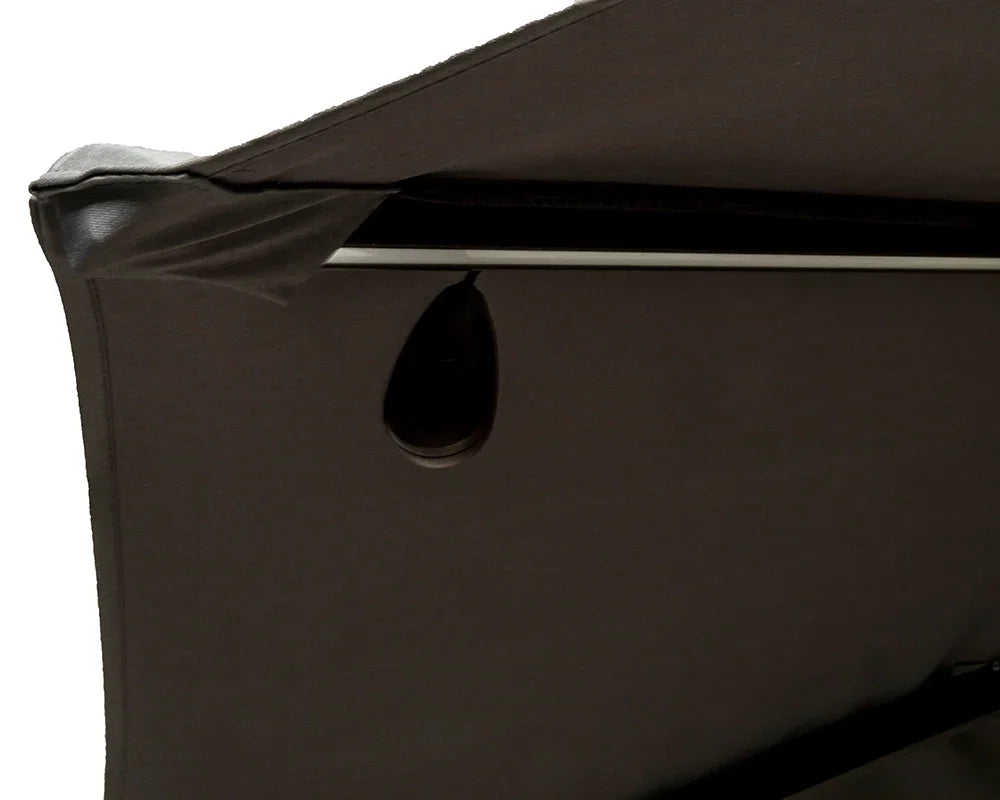 Close up of adjustable fabric canopy with black handle on garden furniture