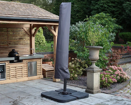 Cantilever parasol with black base and grey cover on patio near outdoor kitchen and garden