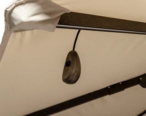 Closeup of garden swing canopy frame with hanging switch and beige fabric cover