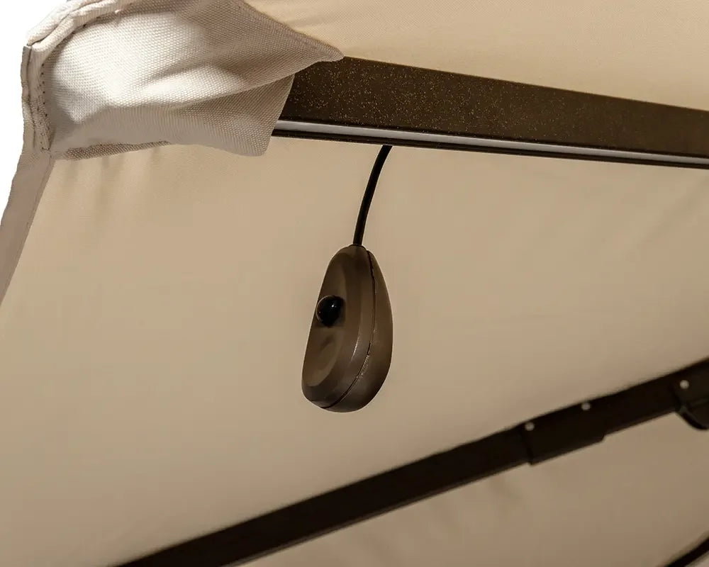 Closeup of garden swing canopy frame with hanging switch and beige fabric cover