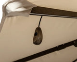 Closeup of garden swing canopy frame with hanging switch and beige fabric cover