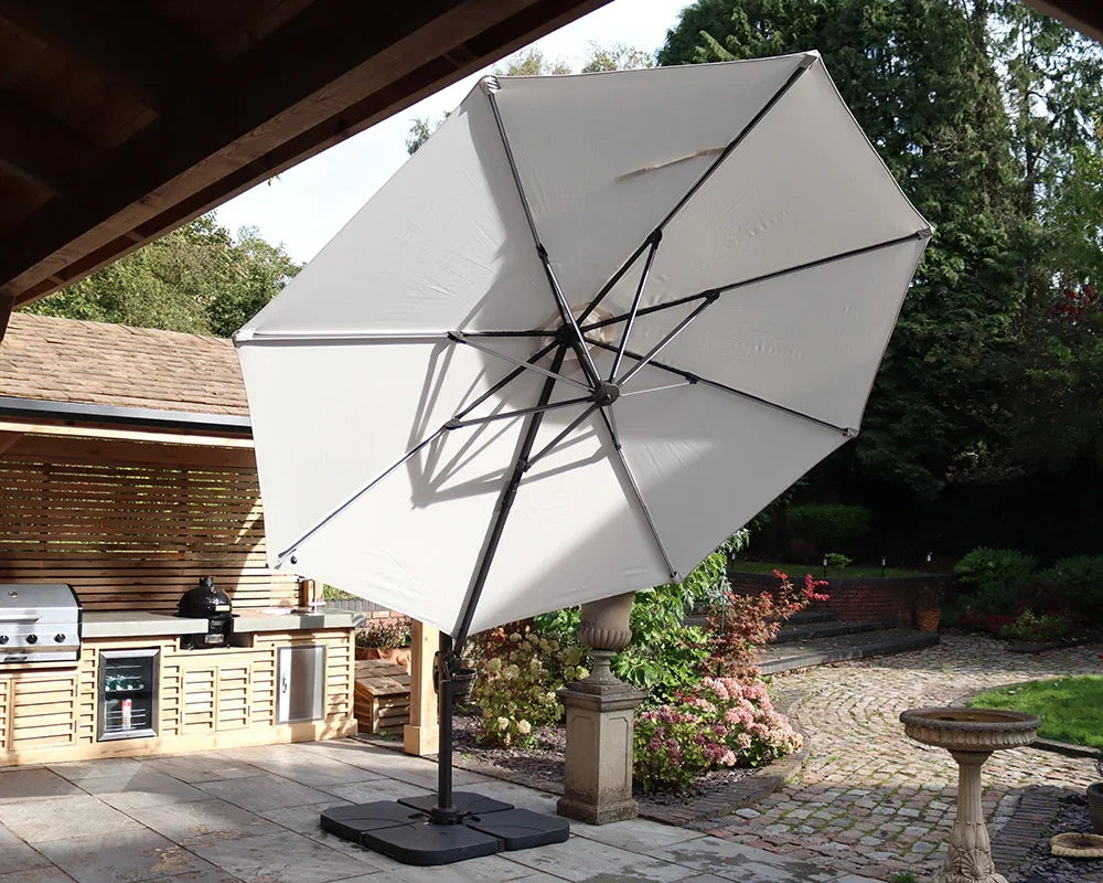 Beige cantilever garden parasol with sturdy base shading patio near outdoor kitchen