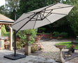 Cream cantilever garden parasol with sturdy base on patio beside landscaped garden