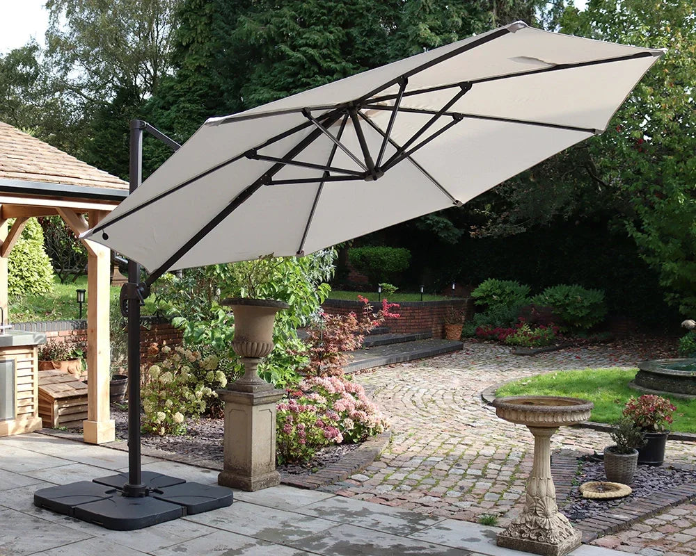 Cream cantilever garden parasol with sturdy base on patio beside landscaped garden