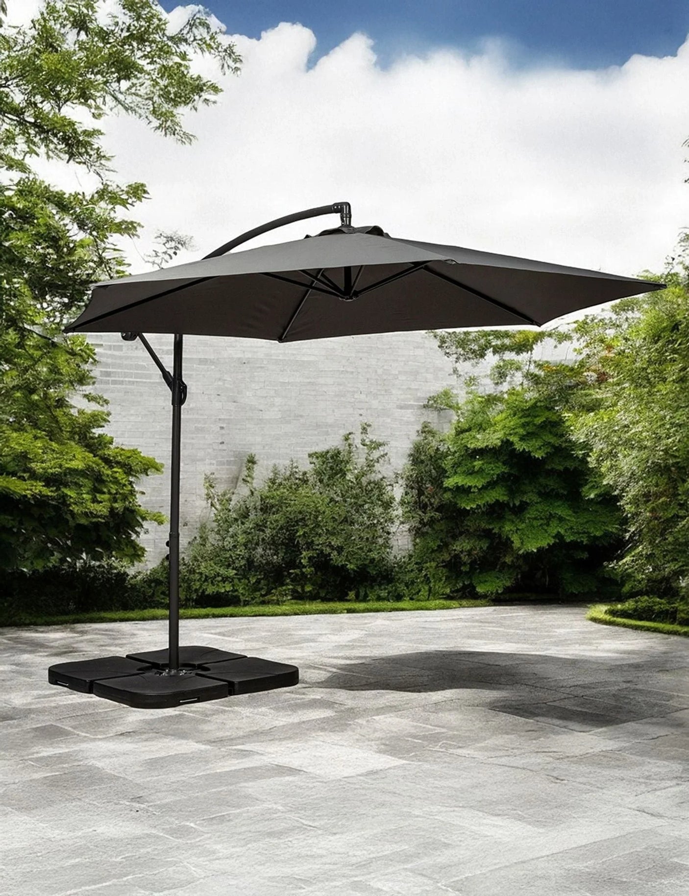 Cantilever garden parasol with dark canopy and sturdy base on stone patio