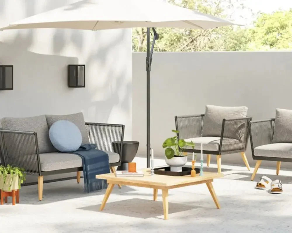 Grey outdoor sofa set with rope detailing, wooden legs, coffee table and patio umbrella
