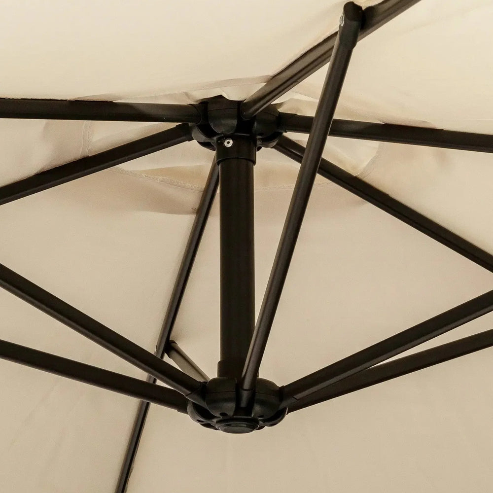Close-up of beige outdoor parasol canopy with black metal frame and support arms