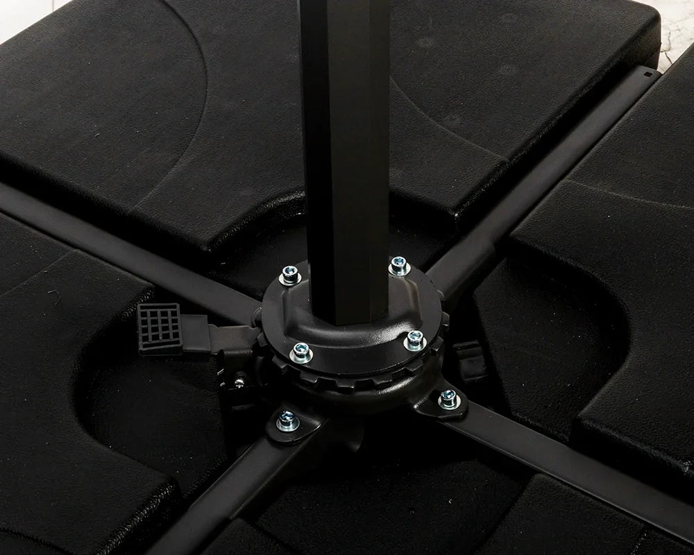 Black parasol base with cross support arms and secure bolt fittings on patio