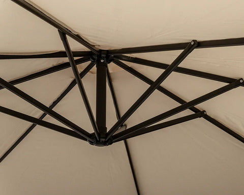 Closeup of beige garden parasol canopy with black metal support frame