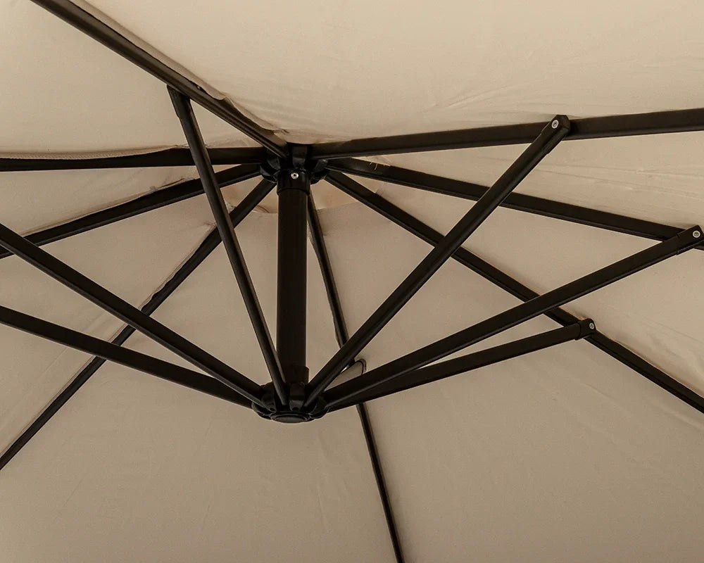 Closeup of beige garden parasol canopy with black metal support frame