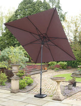Brown cantilever garden parasol with black base on stone patio in landscaped backyard