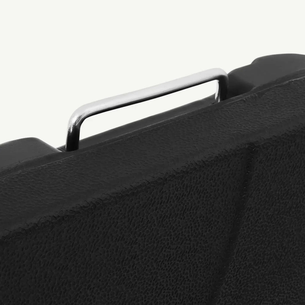 Textured black case with silver metal handle close up, durable storage solution detail