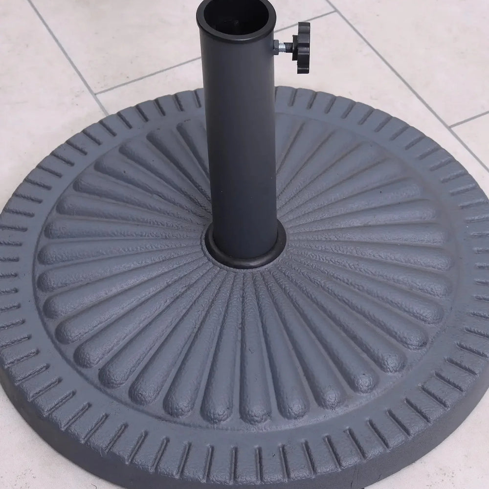 Round cast iron parasol base with ribbed pattern on tiled patio floor