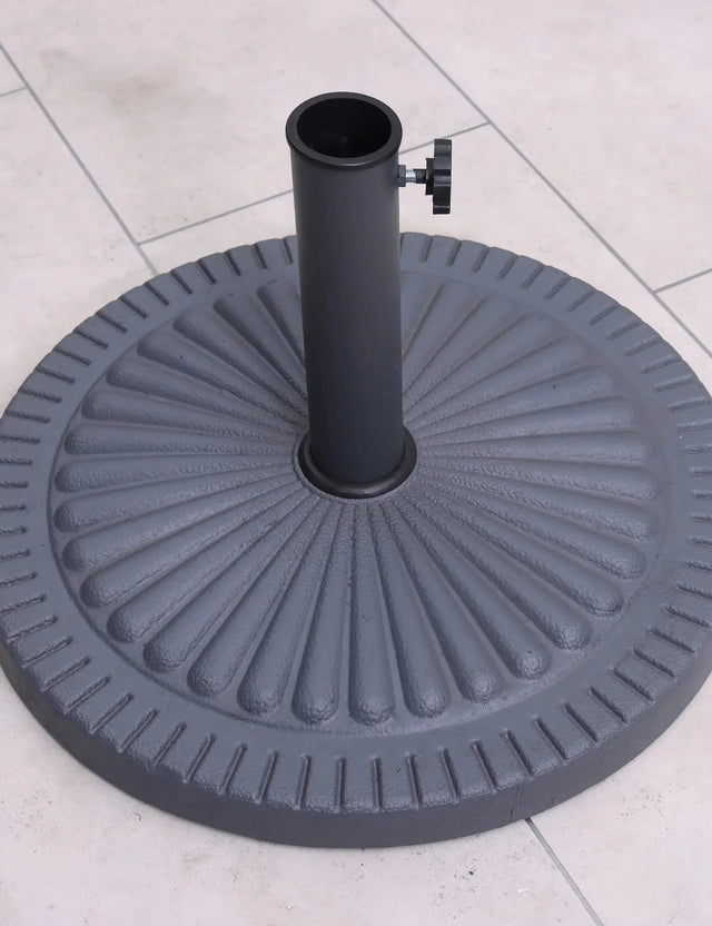Round cast iron parasol base with ribbed pattern on tiled patio floor