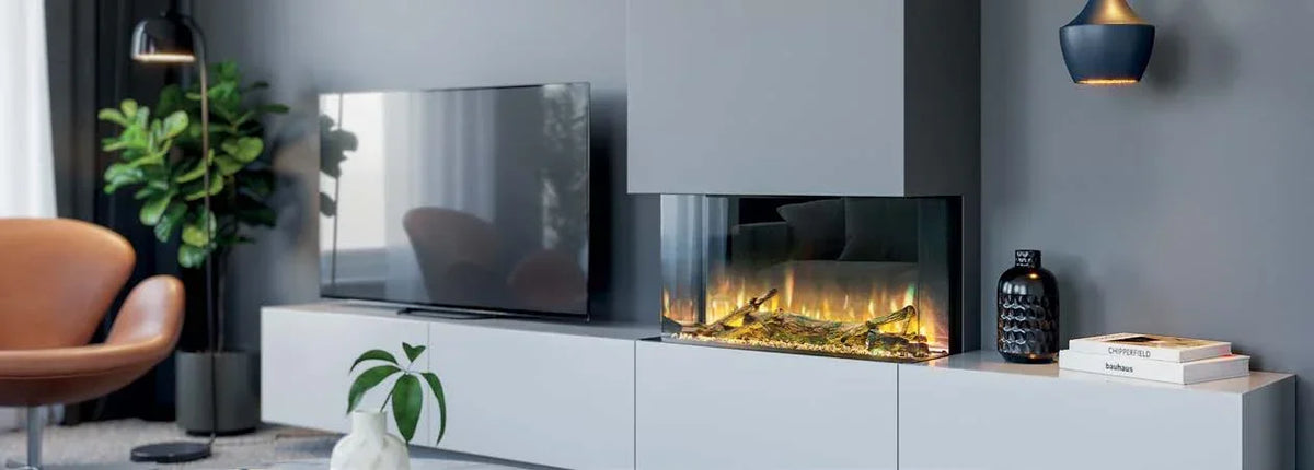 Modern electric fireplace with realistic flames in grey living room, TV and decor nearby