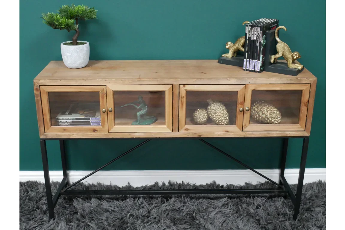 Rustic wood console table with glass doors, black metal legs, and decorative home accessories