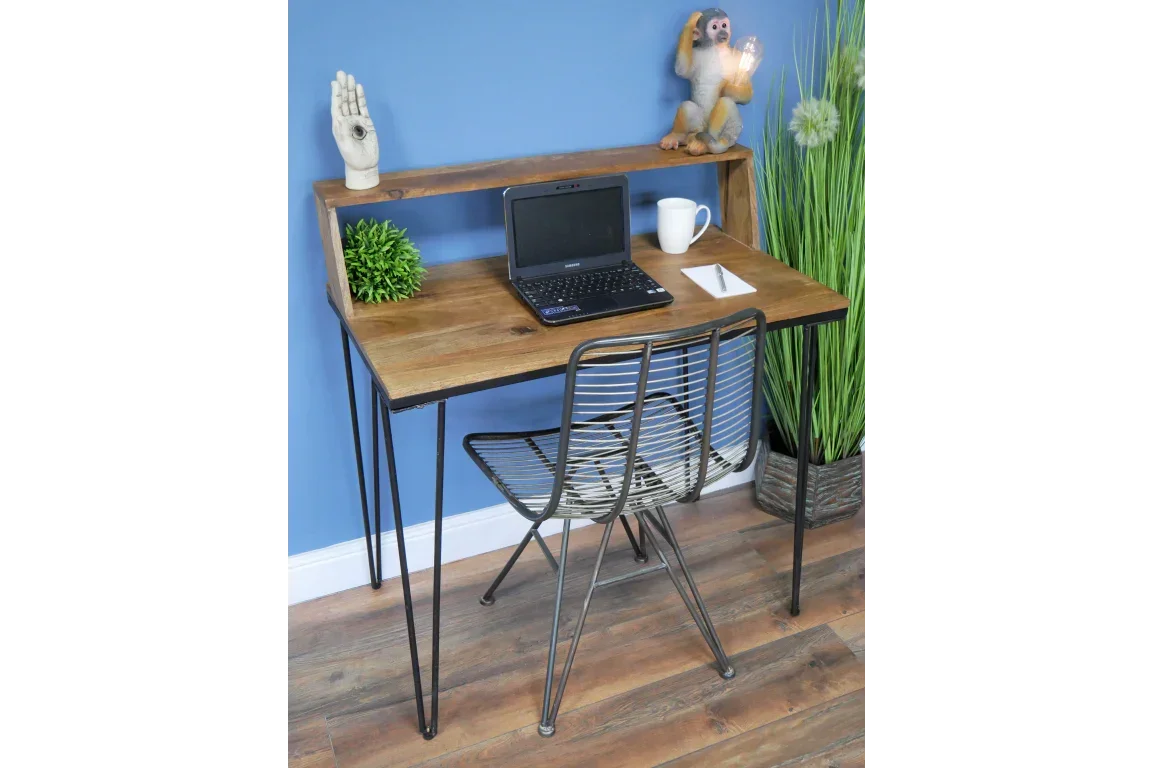 Industrial wooden desk with black metal legs, wire chair, laptop and decorative shelf