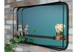 Rectangular black metal framed wall mirror with shelf holding two dog figurines and a decorative light bulb.
