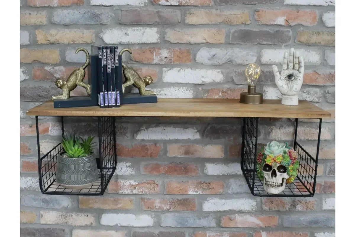 Wall mounted shelf with wire storage baskets, books, gold bookends, and decorative ornaments