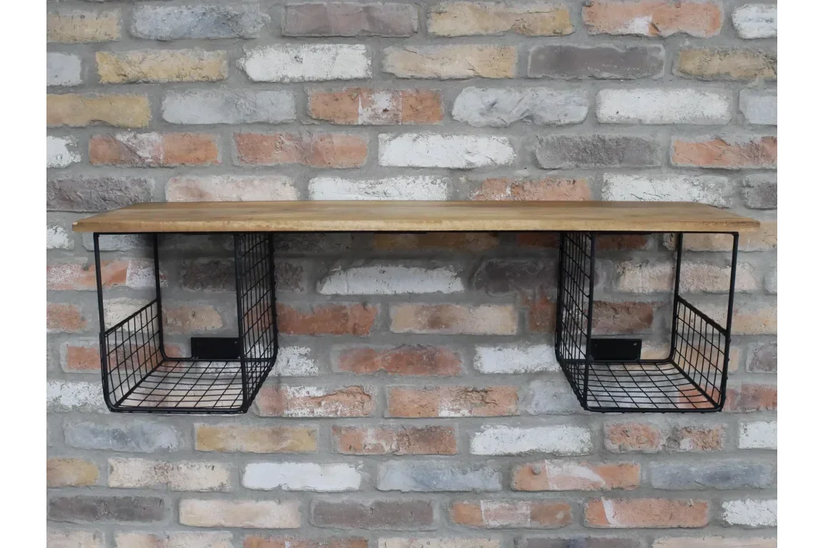 Wall shelf with wooden top and two black wire storage baskets mounted on brick wall