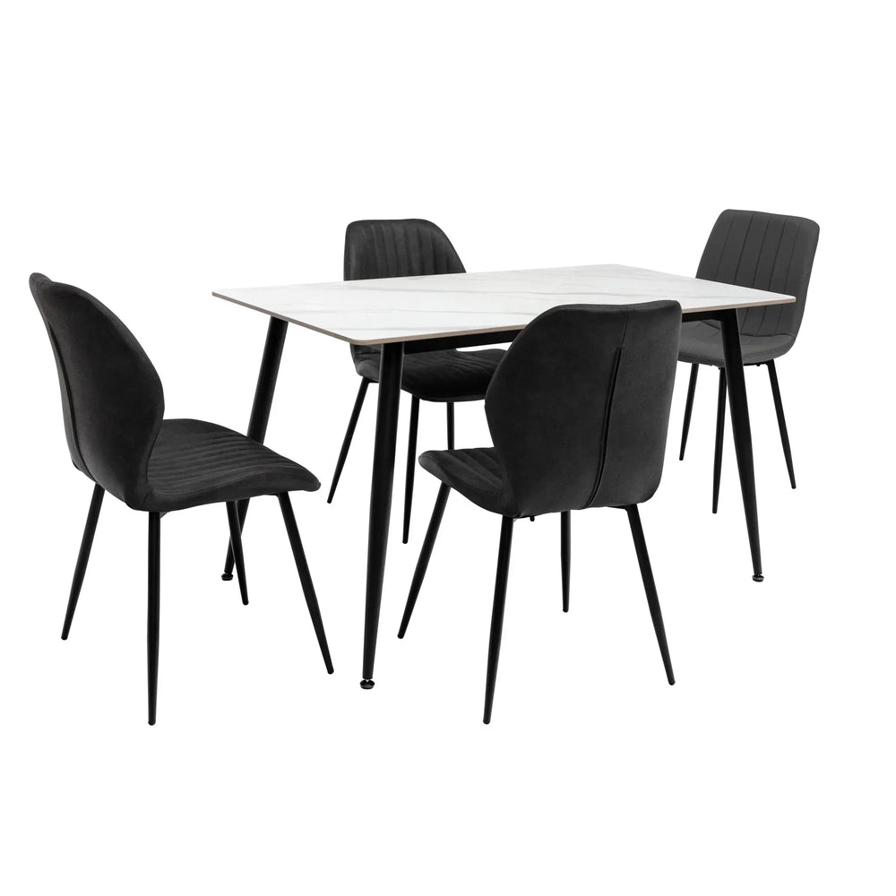 Modern dining table set with white top and four black upholstered chairs on black metal legs