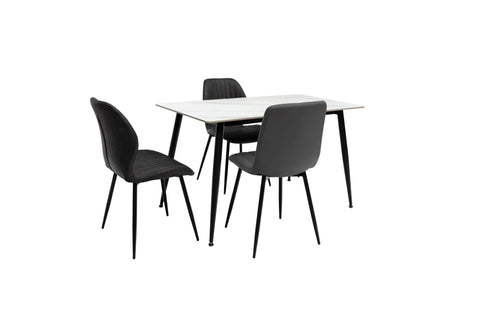 Modern dining table with white top and three black upholstered chairs on black metal legs