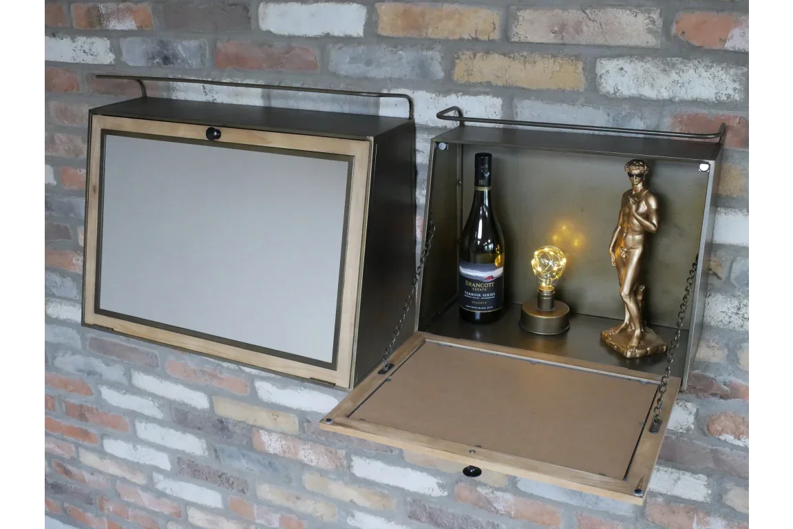 Wall mounted drinks cabinet with drop-down door, bottle, lamp, and gold statue on display