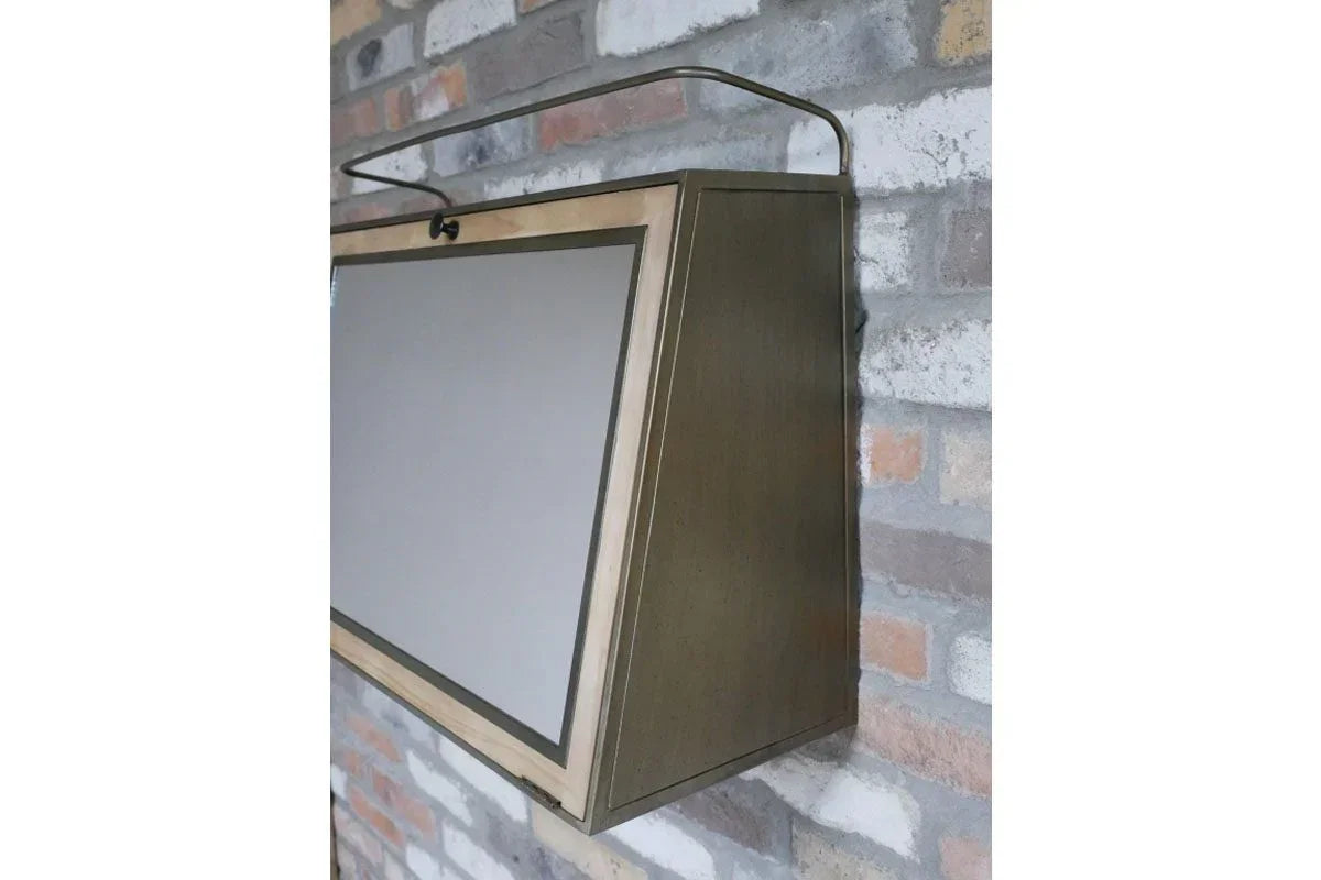 Wall-mounted storage cabinet with angled wooden frame and metal handle against brick wall