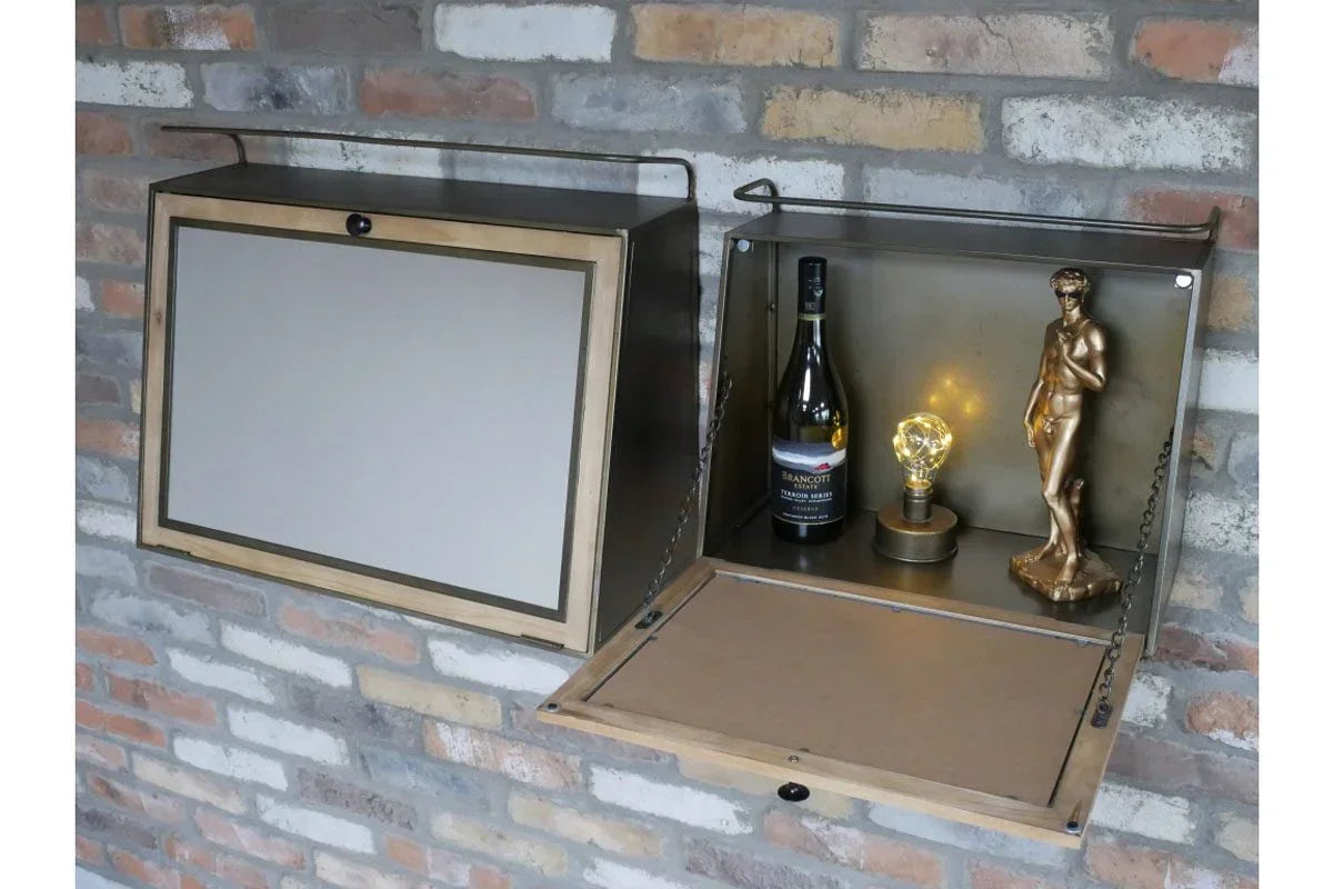Wall-mounted drop-down bar cabinet with wine bottle, lamp and statue on brick wall