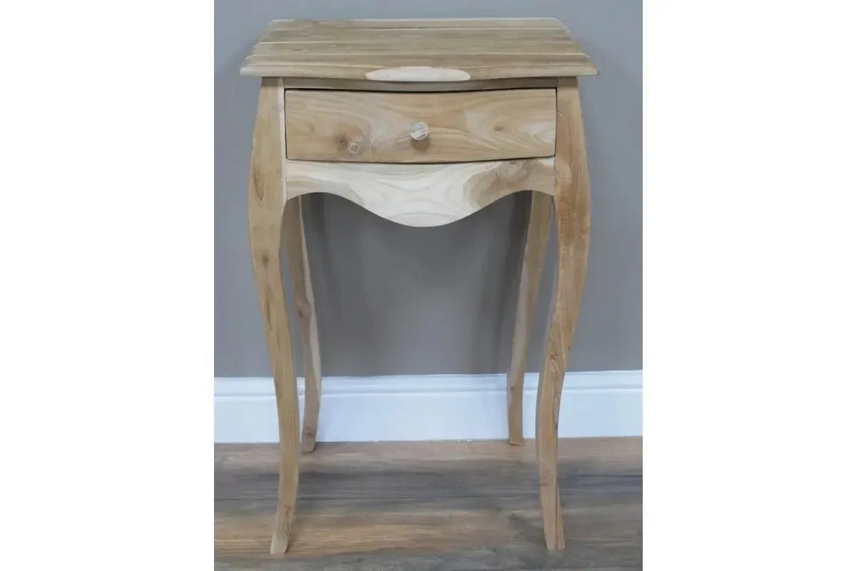 Light wood bedside table with curved legs and single drawer against grey wall